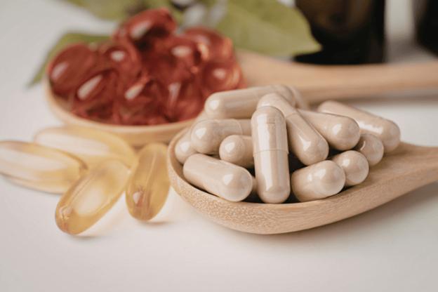 Assortment of health supplements on wooden spoons